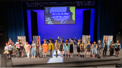 Phoenix College Fashion Club members produced the 2024 Fashion show centered on fashion illustrations and denim; the designers and models pose on stage after the show