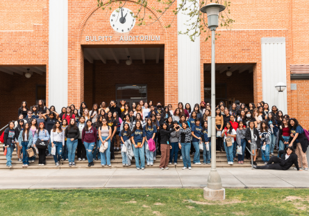 Hermanas Conference participants gather outside Bulpitt Auditorium for a group photo. 