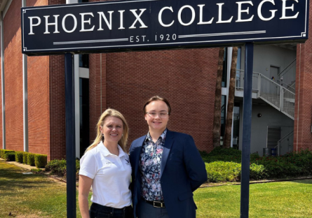 Ryan Young with PC President Dr. Kimberly Britt by Physical Sciences Building and Phoenix College signage
