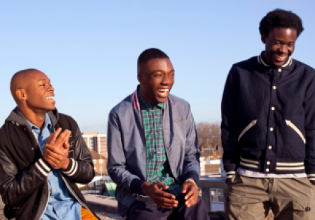 Three black men gather as part of a Phoenix College initiative to uplift men of color on college campuses