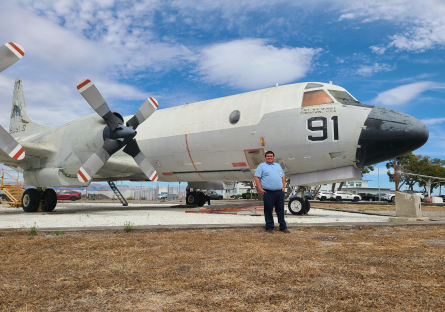 Jesus Zermeno stands next to a plane at NASA Ames Research Center