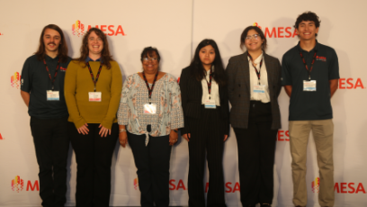 Phoenix College students and staff stand in front of the step and repeat backdrop at the MESA Student Leadership Conference in San Diego. 