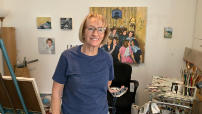 Patrice Sullivan stands in her home studio with her painting works in progress behind her.  A retired painting professor, she recently branched and took at photography course at Phoenix College. 