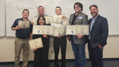 Members and advisors of Phoenix College's Future Business Leaders of American (FBLA) collegiat club hold up the eleven awards won by the team at the Winter Leadership Conference