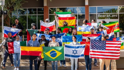 Phoenix College students hold up flags from their respective countries