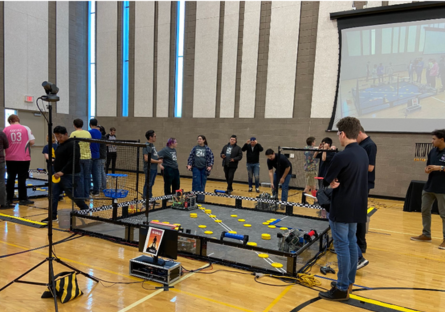 The team driving the robots in the arena during the competition 