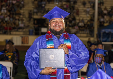 PC male graduate showing off diploma