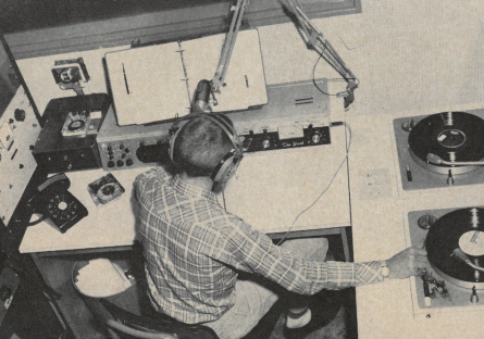 A student in Phoenix College's radio station in the 1950s with microphone, two turntables and other equipment