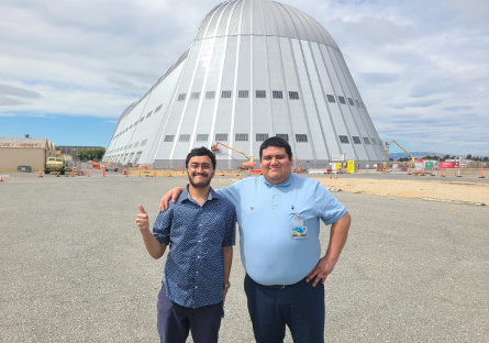 Varun Murale and Jesus Zermeno in front of a building at NASA Ames research center as part of their work in NCAS:Misson 3