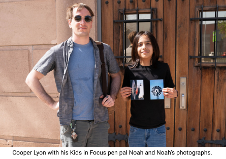 Phoenix College student Cooper Lyon with his pen pal Noah showing off his photos for a Kids in Focus exhibition 