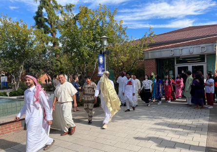 Phoenix College students and staff walk in the International Fashion show wearing traditional clothing from countries around the world