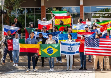 Phoenix College students hold up flags from their respective countries