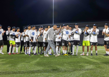 Phoenix College Men's Soccer Head Coach David Cameron gives his players a high five after their championship win