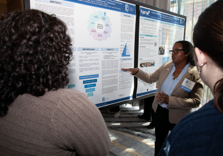 PC student and Helios Scholar Tanya Daniels presents her scientific poster at the Helios Symposium