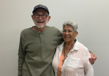 Former Phoenix College students Pat Murphy and Angela Perea-Murphy stand side by side, Pat's arm around Angela.