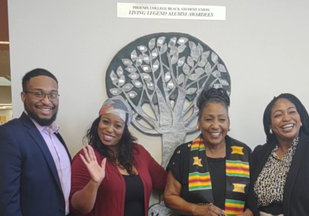 Dr. Debbie Webster stand with her 23-year old grandson and two daughters in front of the Living Legacy Award Tree in Fannin Libray