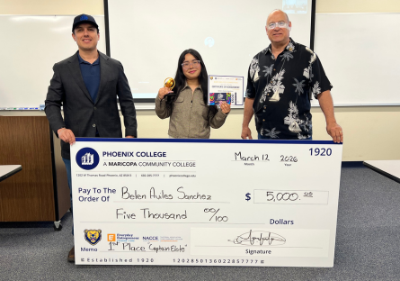 Belen Aviles Sanchez stands with her 1st place award and an oversized check made out to her for $5000 with judges Cesar Sala and Fidel Atencio standing on her left and right side.  