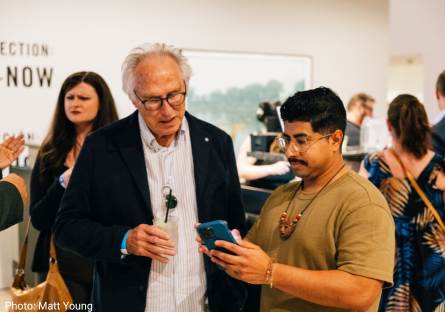 Edgar Fernandez shows Eric Fischl an image on his phone during the most recent Eric Fischl Lecture Series at the Phoenix Art Museum 