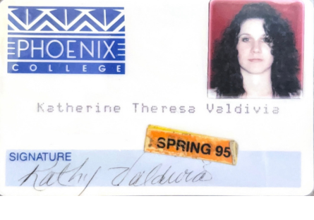 Kat Valdivia's first Phoenix College ID  with the old Phoenix College logo, her full name Katherine Theresa Valdivia, her signature, her picture which shows her long brown curlyl hair and an orange "Spring 95" sticker.