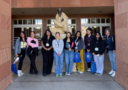 Kat Valdivia stands outside with her eight of her Phoenix College Education student a conference for educators. 