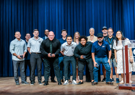 Phoenix College administrators and Men's soccer coaches collect their championship rings and stand for a photo on Bulpitt stage