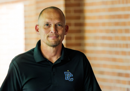 PC Men's Soccer Head Coach Dave Cameron outside Bulpitt Auditorium before the championship celebration