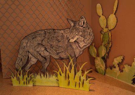 a print of coyote is mounted on board and installed upright in the corner of a rust colored room