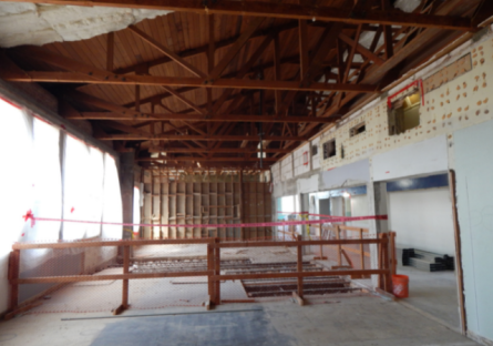 Image of wooden trusses on second floor during renovation