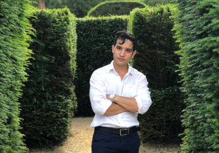 picture of Reynaldo amid a garden in Europe