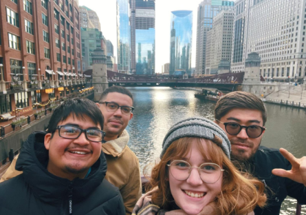 Four students posing in front of a canal in Chicago