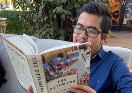 Nate Damian reading a book titled The Ottomans
