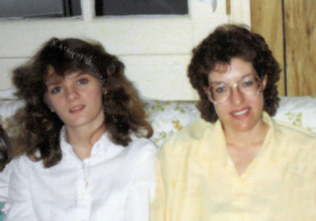 Kimberly as a young teen sitting on a couch with her foster mother