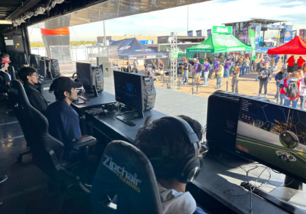 Angel, Adriel, and Miguel sitting in front of game consoles looking out over Phoenix Raceway