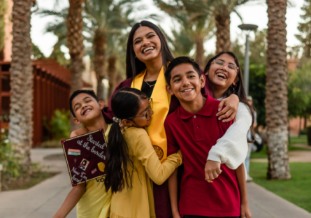 Phoenix College transfer student Sandra Quiroz at her ASU graduation with her nieces and nephews