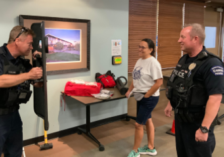 Phoenix College Police Sergeant Ken McWilliams demonstrates use of the ballistic shield to Rose Gilbert and Police Commander Matt Verthein at Safety Days, one of the Fall 2023 Learning Sessions