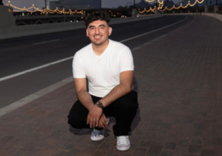 Phoenix College Nursing student Victor Salinas on a bridge smiling; he is recipient of the Equality Maricopa PRISM Scholarship