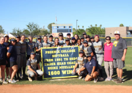 Phoenix College Softball Head Coach Heinz Mueller standing with staff and current team celebrates his 1600 win