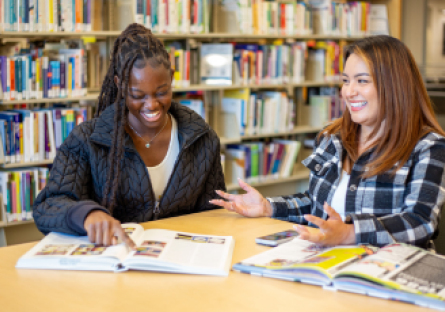 Two Phoenix College students discuss coursework in the Fannin Library