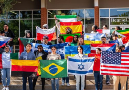 Phoenix College students hold up flags from their respective countries