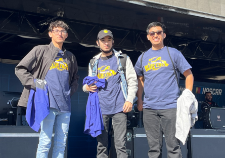 Esports participants–Angel, Adriel, and Miguel–standing at the Phoenix Raceway
