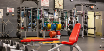 free weights, bar bells, benches, mirrors in the PC Fitness Center