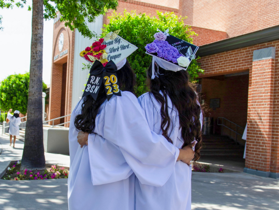 Two Phoenix College graduates embracing after the Nursing Pinning Ceremony