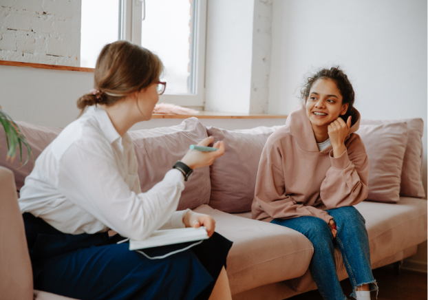 Counseling: Two women sitting on a couch having a conversation